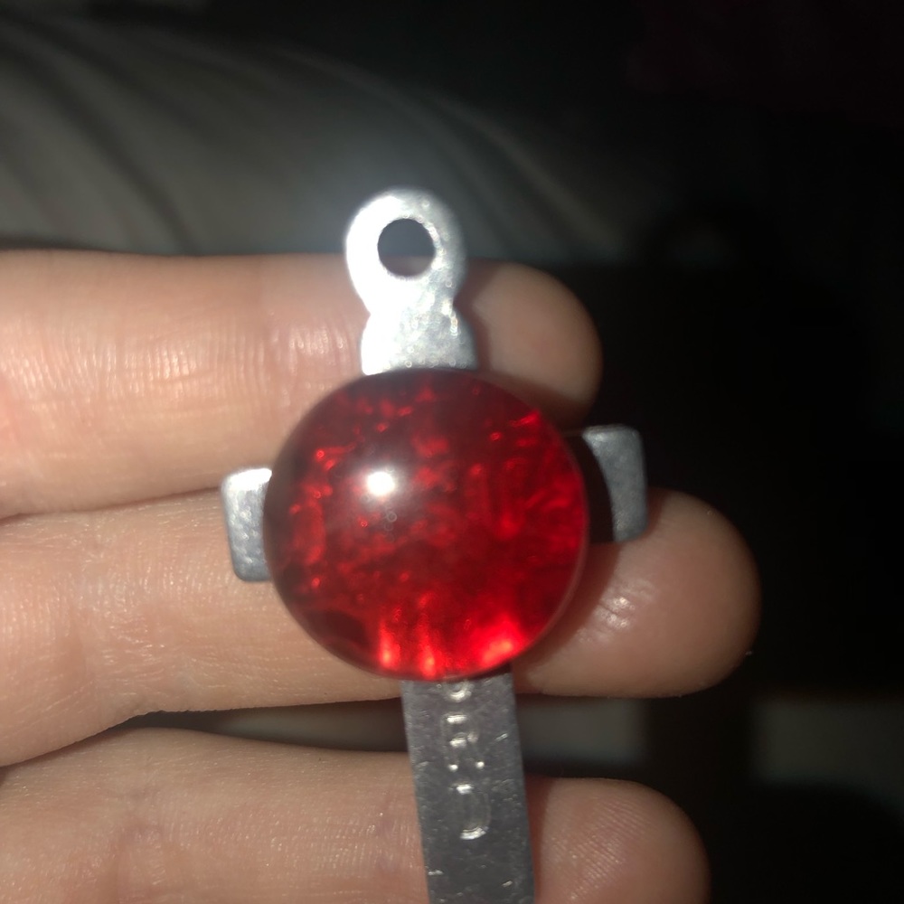 Cross pin with red stone